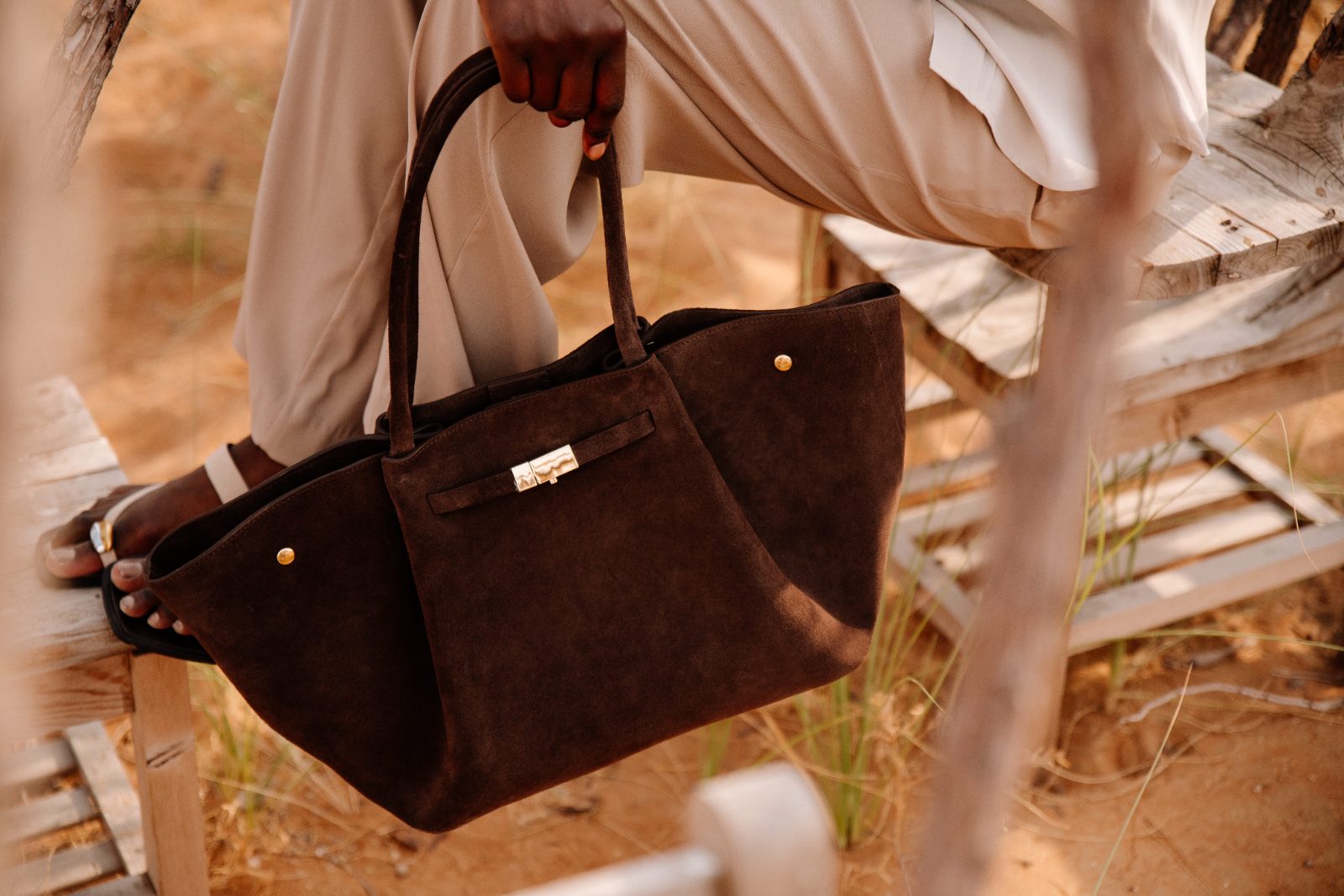 Suede bag carried in hand